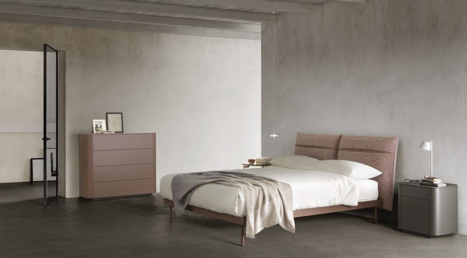 Minimalista habitación de diseño italiano con una funcional cama con compartimentos en el cabecero y un aparador realizando la función de mesita de noche